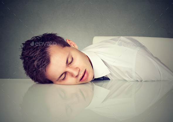 Man sleeping on a desk office table