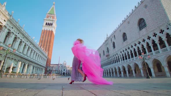 Model Walks Moving Happily in Heels and Pink Dress in Venice alt