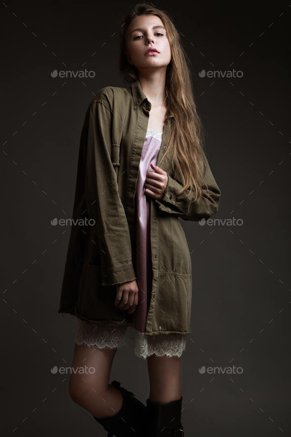 fashion model with long hair, is posing in studio