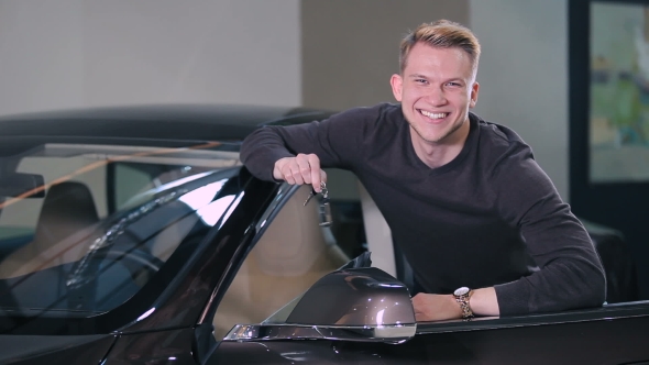 Happy Man Hold a Keys From Electric Car alt