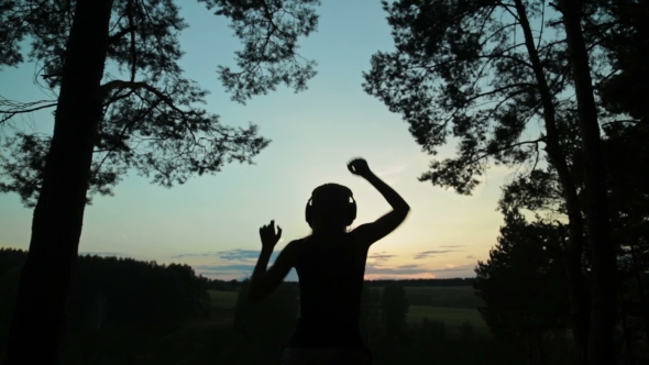 Young Women Dancing In The Forest After Sunset