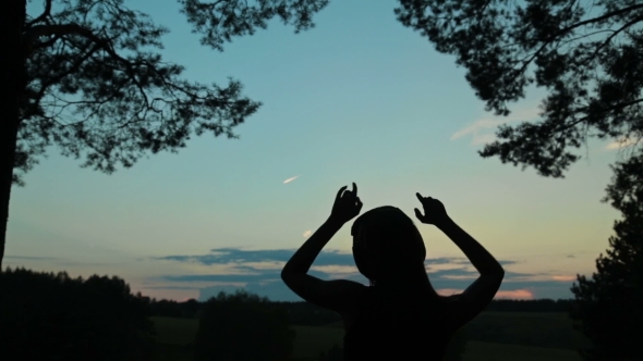 Young Women Dancing In The Forest After Sunset