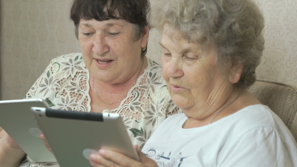 Old Grandmothers Holding Silver Digital Tablets