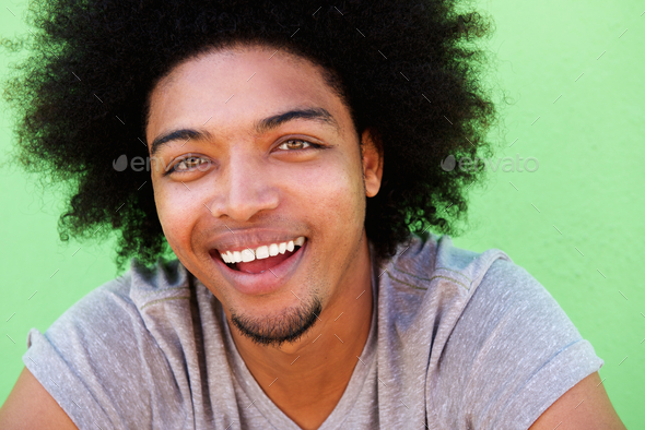 Young african american guy with afro laughing