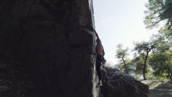 Professional Climber On Cliff Giving Instructions To Somebody alt