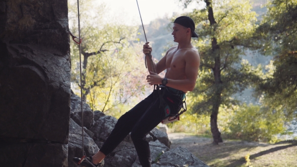 Climber Jumping From Cliff While Hanging On Rope alt