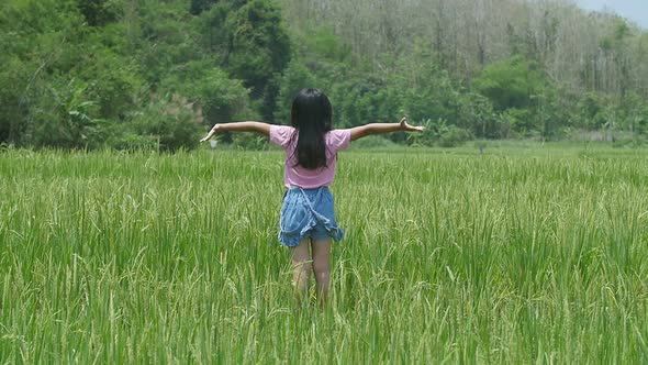 Little Girl Rejoicing In Rice Field alt