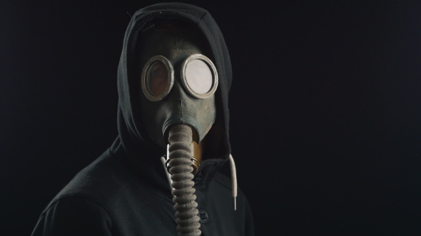 Portrait Of a Man In a Hood With Gas Mask Covering His Face., Stock Footage