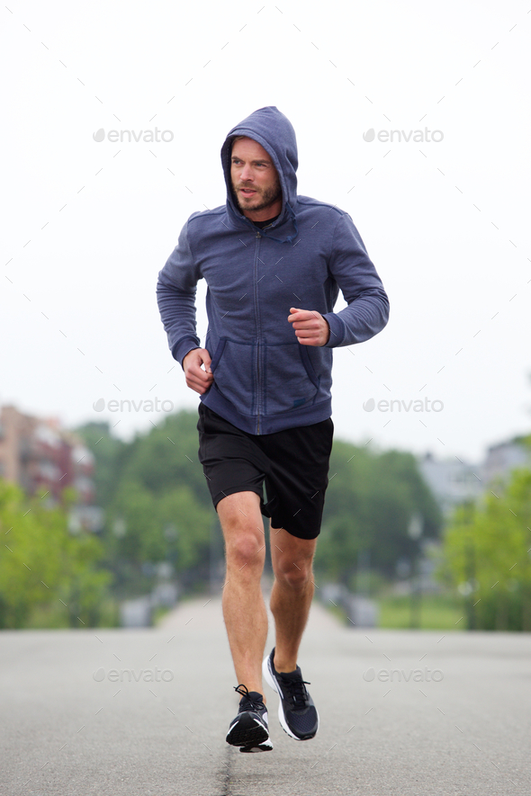Beautiful carefree middle age runner outside