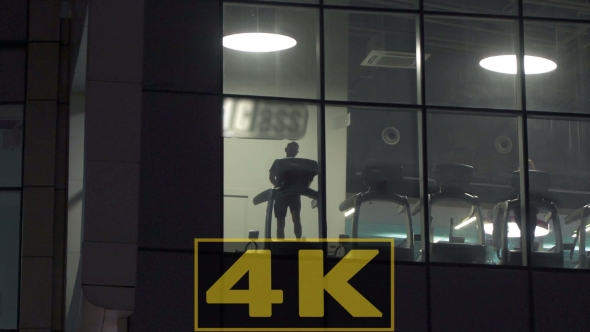 Fitness Center View Through The Glasss In Buisness City At Night alt