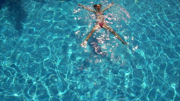 Young Woman Enjoying a Pool.