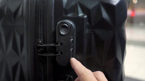 Man's Hands Open Suitcase Combination Lock on the Suitcase alt