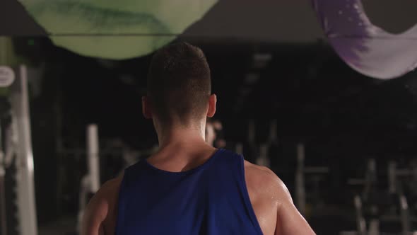 Close up of a man training with the dumbbells alt