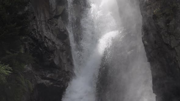 Detail static slowmotion shot of the La Pisse waterfall. The water goes down and up. French Alps. Pr alt