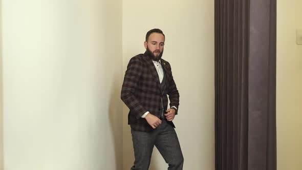 Stylish Young Man In Clothing Store Posing In New Suit. alt