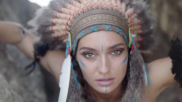 Embracing Portrait of an Astonishing Wild Woman with Bright Makeup and Native American Culture alt