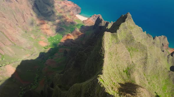 Drone Video Above Helicopter Flying Low Below in Green Tropical Napali Canyon alt