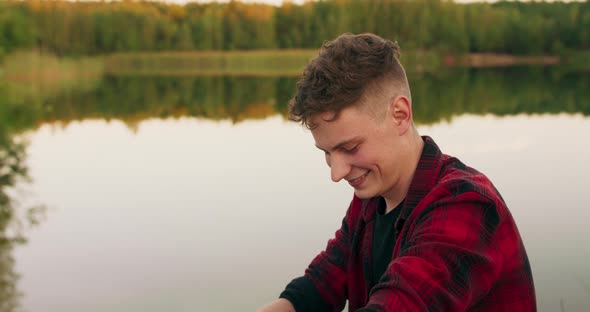 Portrait of Young Boy Joking with Their Friends and Drinking Beer While Having a Picnic at the alt