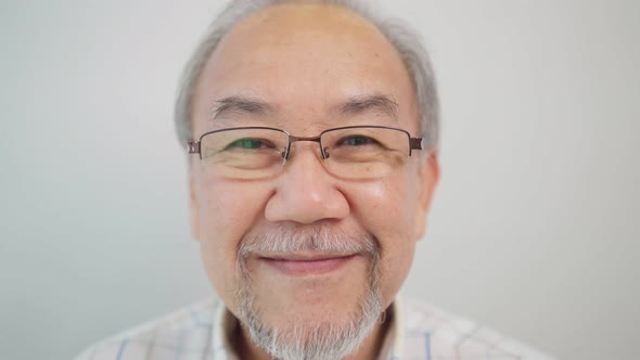 Portrait of happy Asian senior man looking and smiling to camera