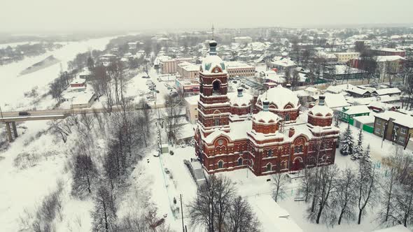 Beautiful Winter Landscape Aerial View a Town on the River Bank and a Church alt
