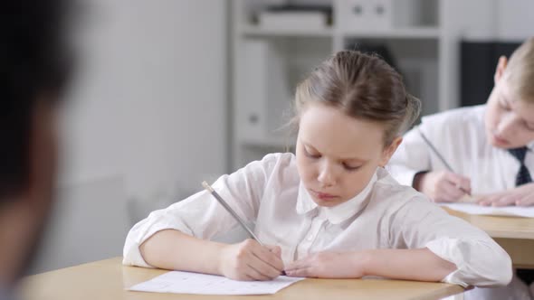 Preteen Schoolgirl Filling Out Test Answer Sheet alt