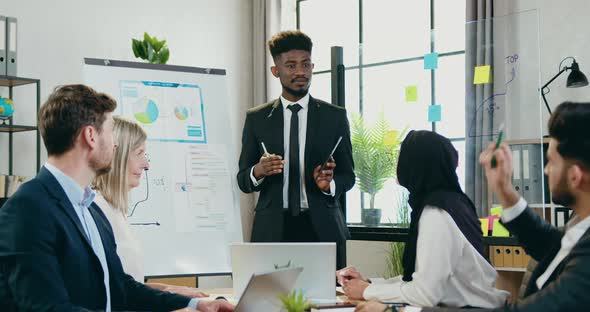 Male Speaker Discussing with Multiethnic Corporate Coworkers Joint Business Strategy by Voting alt