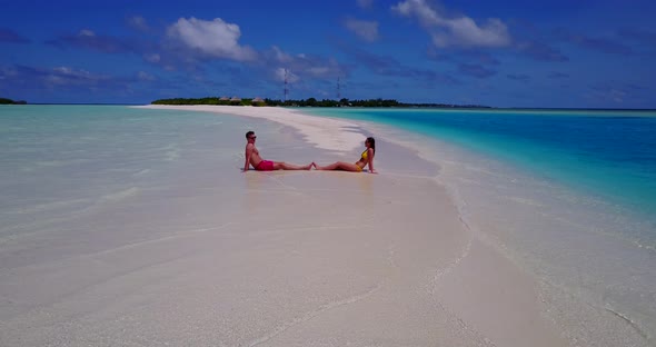 Romantic couple on honeymoon vacation live the dream on beach on paradise white sand background  alt