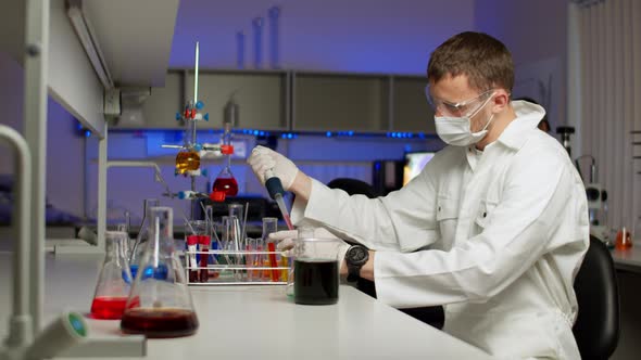 Young Scientist Mixing Colored Liquids