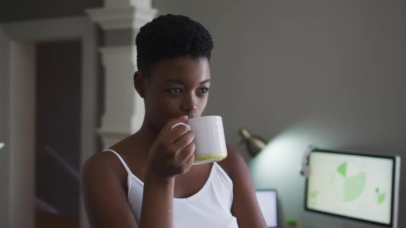 African american woman drinking coffee at home alt