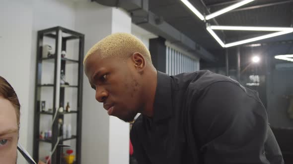 Afro-American Hairdresser Working with Client in Barbershop alt