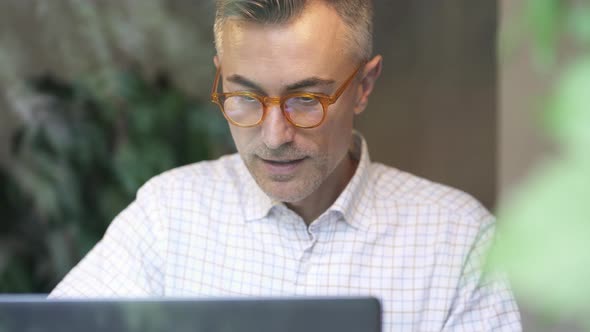 happy man working with laptop.