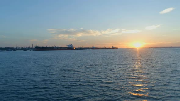 Sunset Over Southampton Docks With Ships Being Loaded With Cargo alt