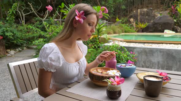 Slow Motion of Young Slim Woman Eating Healthy Smoothie Bowl alt