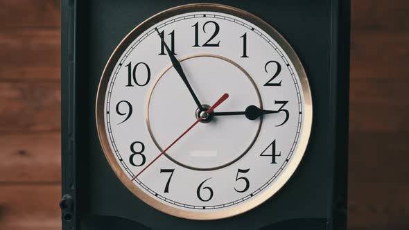 Vintage Wall Clock with Moving Second Hand on Wooden Background alt