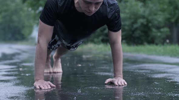 Man Do Push-ups at Rain the Street alt