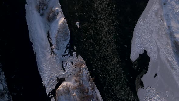 Top Down Close Up Aerial Drone View on the Frozen River Floating Ice