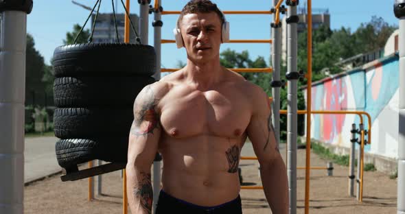 Portrait of Male Athlete Doing Exercises Outdoors in Summer alt