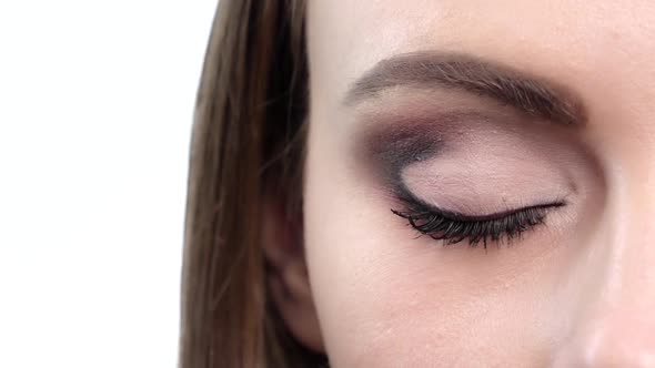 Woman Eye with Bright Makeup. Close Up. Slow Motion alt