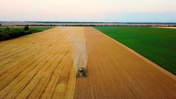 Harvester in a Field at Sunset