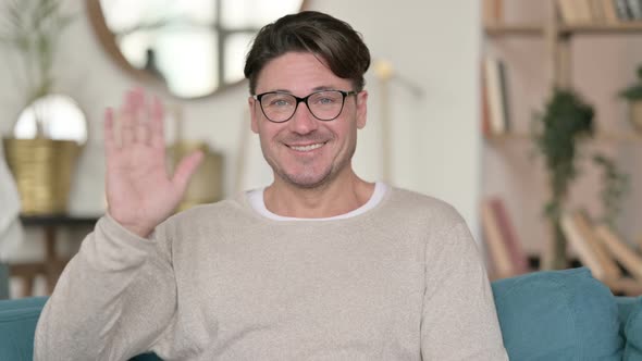 Middle Aged Man Waving at Home  alt