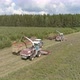 Aerial view of two Combines harvesting, trucks and tractor on grass field. 30 - VideoHive Item for Sale