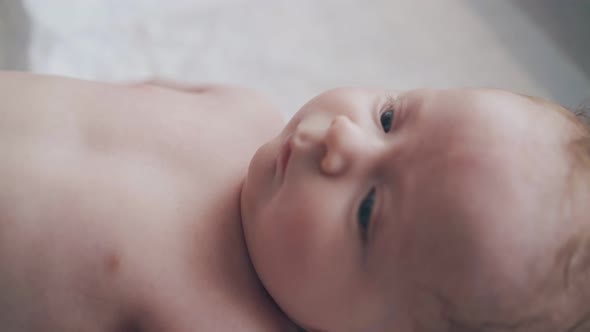 Adorable Newborn Boy with Short Fair Hair and Blue Eyes alt