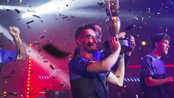 Team Leader with Trophy Near Teammates alt