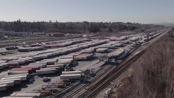 Container dock between railway and highway at Vancouver shipping terminal in Canada. Aerial circling alt