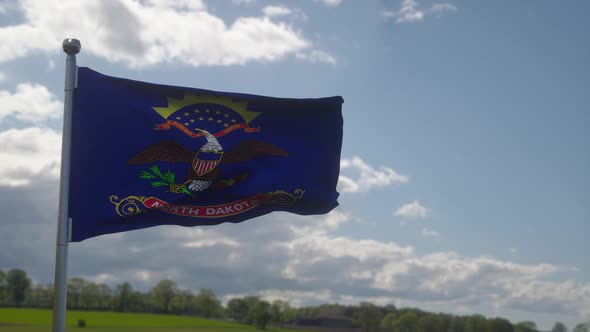 Flag of North Dakota State Region of the United States Waving at Wind alt