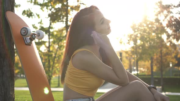 Beautiful Young Woman Listens to Music with Headphones alt