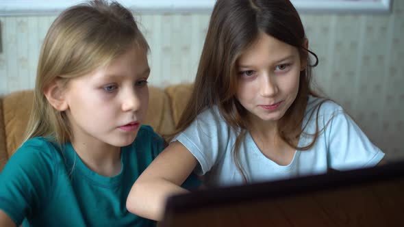 Kids Surfing Internet Together on Laptop alt