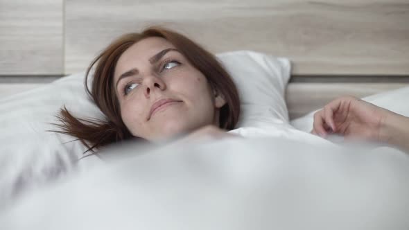 Beautiful Woman is Sad in Bed at Home Herself on Selfisolation During Quarantine alt