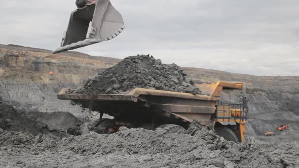An Excavator Bucket Digs Coal