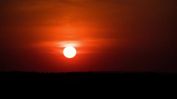 Dramatic Sunset Through the Clouds Above the Horizon. Timelapse. alt